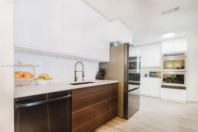 10300 NW 80th Ct, Tamarac, FL 33321 - kitchen with stainless steel appliances, modern cabinets, a sink, and white cabinetry