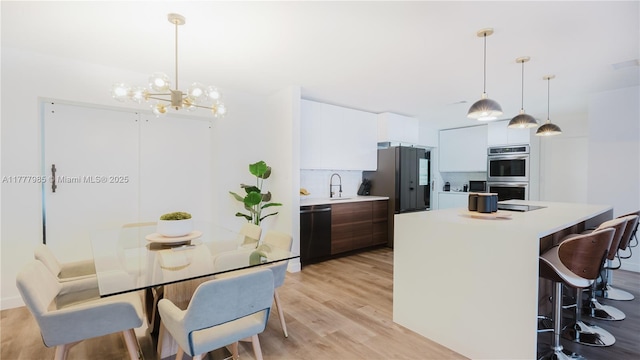 10300 NW 80th Ct, Tamarac, FL 33321 - kitchen with dishwasher, double oven, light countertops, a center island, and a chandelier