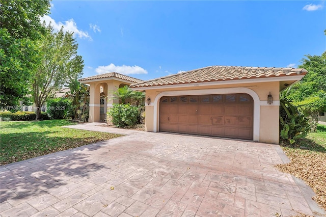 4622 NW 100th Ter, Coral Springs, FL 33076 - mediterranean / spanish-style home featuring stucco siding, decorative driveway, a tile roof, a garage, and a front yard