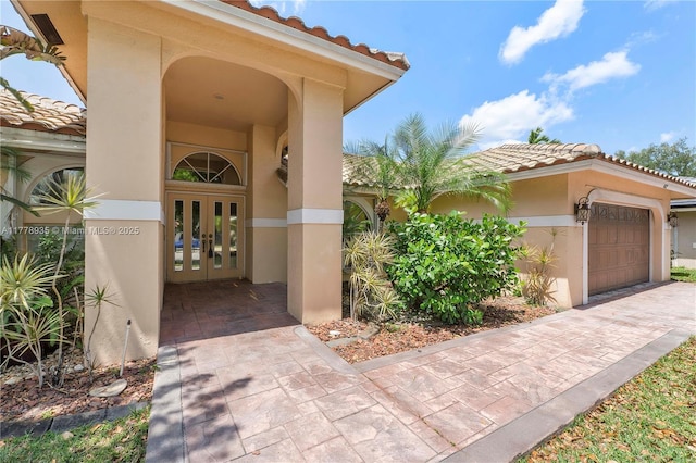 4622 NW 100th Ter, Coral Springs, FL 33076 - property entrance with french doors, a tile roof, and stucco siding