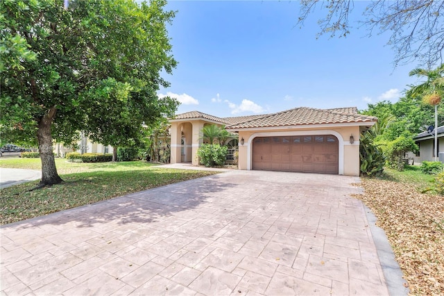 4622 NW 100th Ter, Coral Springs, FL 33076 - mediterranean / spanish house featuring stucco siding, decorative driveway, a garage, and a tiled roof