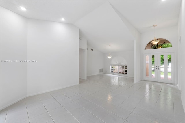 4622 NW 100th Ter, Coral Springs, FL 33076 - unfurnished living room featuring light tile patterned floors, french doors, high vaulted ceiling, and recessed lighting
