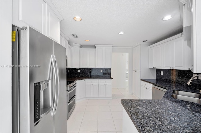 4622 NW 100th Ter, Coral Springs, FL 33076 - kitchen featuring stainless steel appliances, light tile patterned flooring, white cabinets, recessed lighting, and a textured ceiling