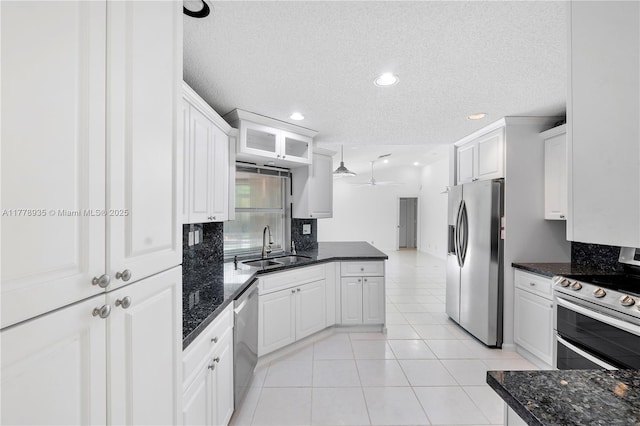 4622 NW 100th Ter, Coral Springs, FL 33076 - kitchen with stainless steel appliances, ceiling fan, a peninsula, white cabinetry, and a textured ceiling