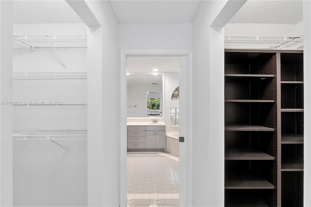 4622 NW 100th Ter, Coral Springs, FL 33076 - walk in closet with tile patterned floors and a sink