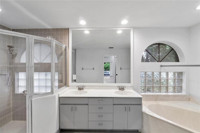 4622 NW 100th Ter, Coral Springs, FL 33076 - full bathroom with a shower stall, a bath, double vanity, and recessed lighting