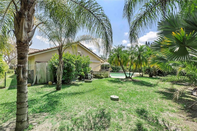 4622 NW 100th Ter, Coral Springs, FL 33076 - view of green lawn featuring an outdoor pool