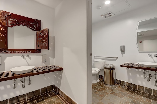 10 SW S River Dr Unit 610, Miami, FL 33130 - bathroom featuring a sink, toilet, and baseboards