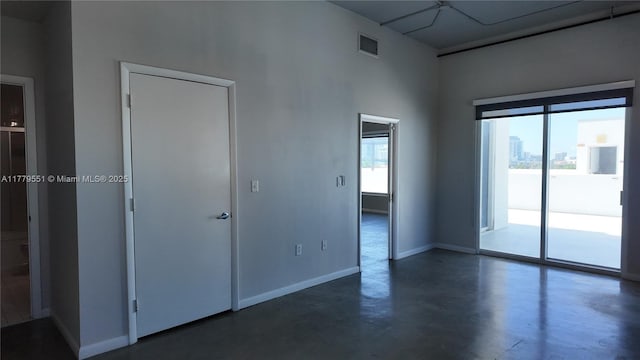 10 SW S River Dr Unit 610, Miami, FL 33130 - spare room with concrete flooring, baseboards, and a high ceiling