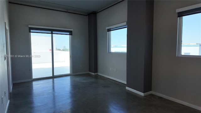10 SW S River Dr Unit 610, Miami, FL 33130 - unfurnished room featuring concrete floors, plenty of natural light, and baseboards