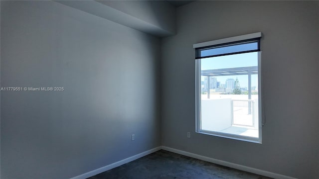 10 SW S River Dr Unit 610, Miami, FL 33130 - spare room with dark carpet and baseboards