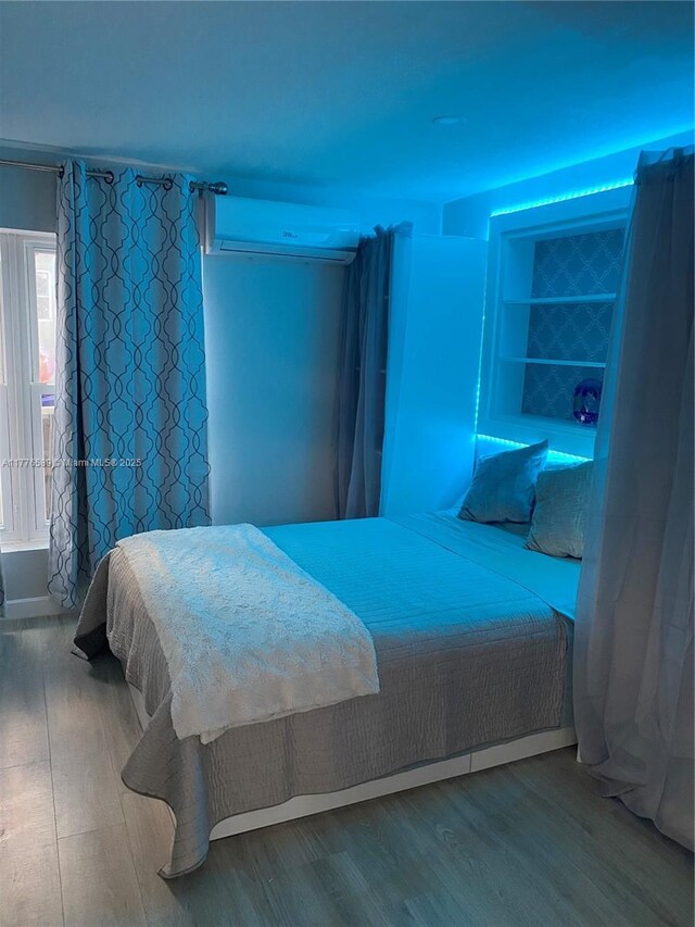 428 N Crescent Dr, Hollywood, FL 33021 - bedroom featuring a wall mounted AC and wood finished floors