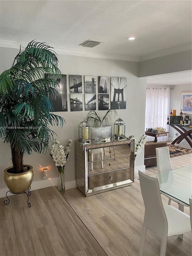 428 N Crescent Dr, Hollywood, FL 33021 - dining space featuring crown molding, wood finished floors, and a textured ceiling