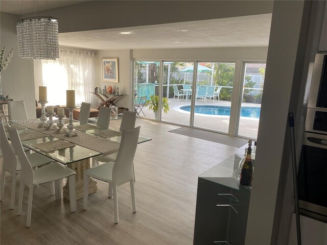 428 N Crescent Dr, Hollywood, FL 33021 - dining room with light wood finished floors and a chandelier