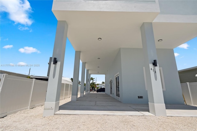 exterior space featuring fence, a patio, and stucco siding