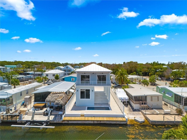 back of property with metal roof and a balcony