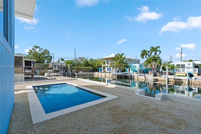 outdoor pool with a patio and a boat dock