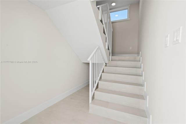 stairway featuring baseboards