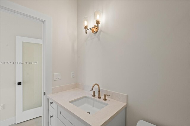 bathroom with toilet and vanity