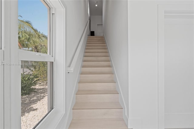 84745 Old Hwy Unit 1, Islamorada, FL 33036 - stairway featuring healthy amount of natural light, a towering ceiling, and wood finished floors