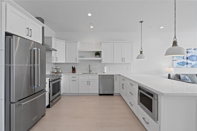 84745 Old Hwy Unit 1, Islamorada, FL 33036 - kitchen featuring premium appliances, open shelves, light countertops, white cabinetry, and a peninsula