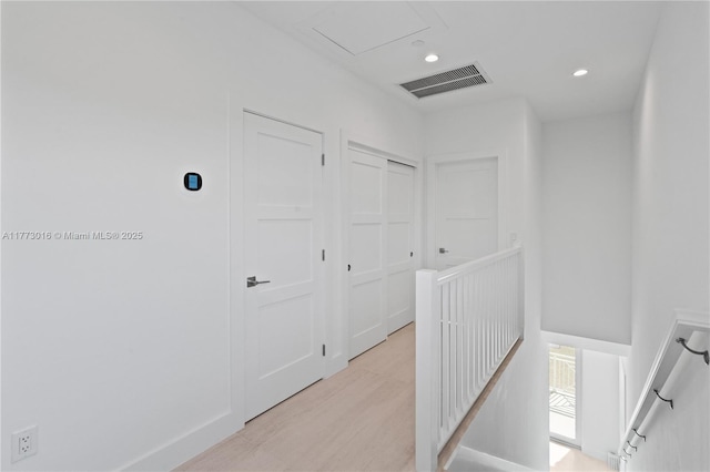 84745 Old Hwy Unit 1, Islamorada, FL 33036 - hallway with an upstairs landing, recessed lighting, and light wood-style flooring