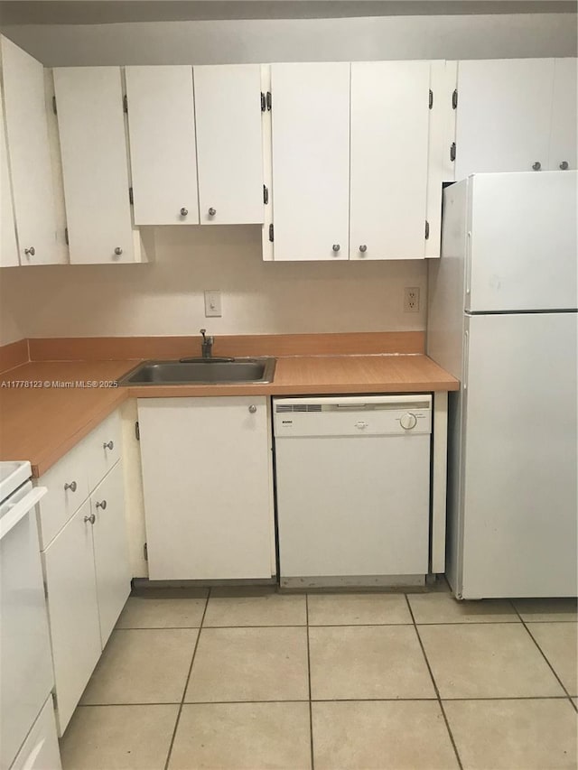 5112 NW 79th Ave Unit 201, Doral, FL 33166 - kitchen with light tile patterned floors, a sink, white appliances, and white cabinets