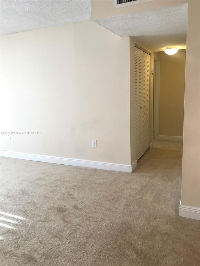 5112 NW 79th Ave Unit 201, Doral, FL 33166 - carpeted empty room with visible vents, a textured ceiling, and baseboards
