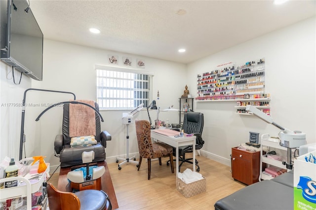 office area featuring recessed lighting, a textured ceiling, baseboards, and wood finished floors
