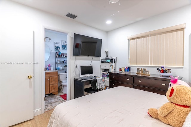 bedroom with visible vents, recessed lighting, ensuite bathroom, and light wood-style floors