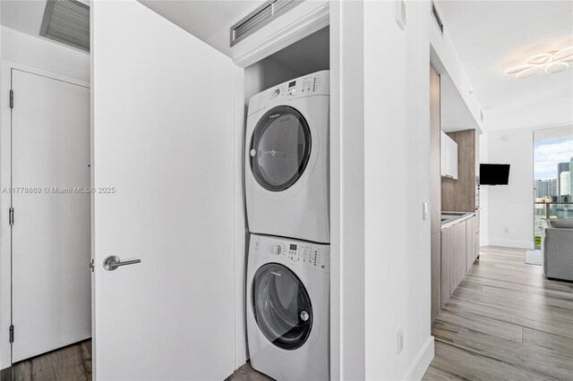 2900 NE 7th Ave Unit 1609, Miami, FL 33137 - washroom with stacked washer / dryer and light wood finished floors