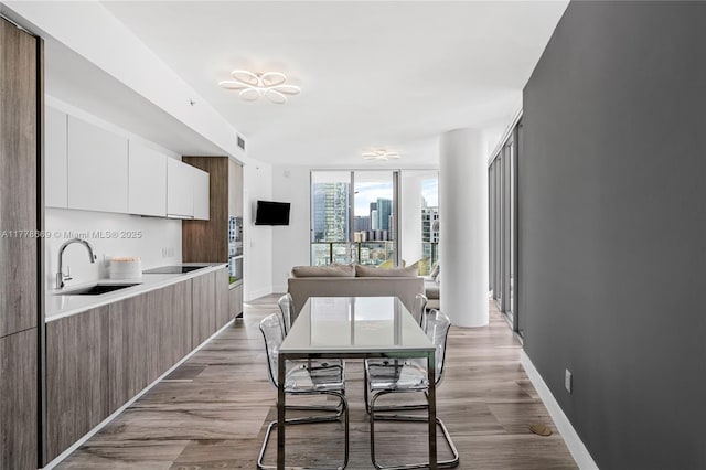 2900 NE 7th Ave Unit 1609, Miami, FL 33137 - dining space featuring light wood-type flooring and a wall of windows