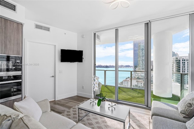 2900 NE 7th Ave Unit 1609, Miami, FL 33137 - living room with healthy amount of natural light, wood finished floors, and floor to ceiling windows