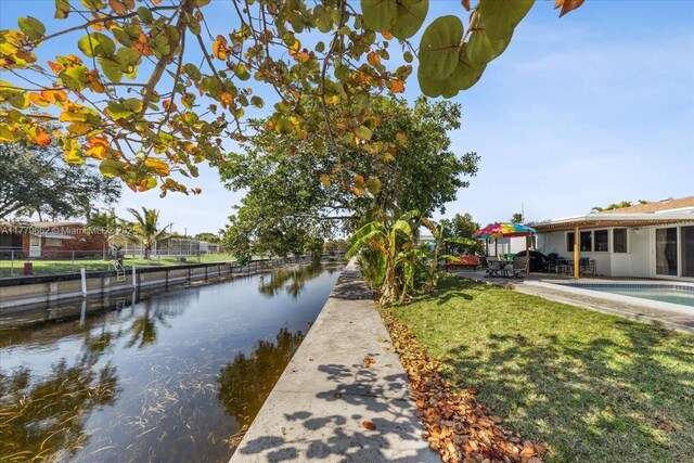 1625 E River Dr, Margate, FL 33063 - view of swimming pool featuring a patio, a storage unit, and an outdoor structure