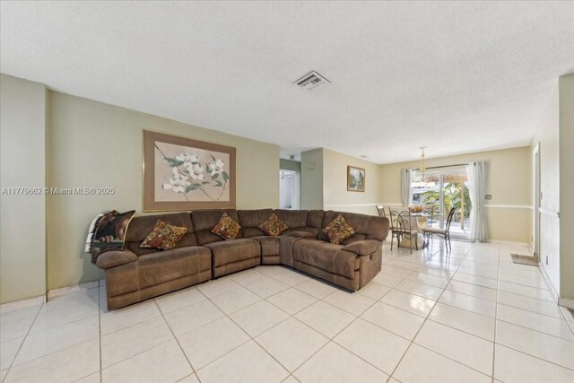 1625 E River Dr, Margate, FL 33063 - living room featuring a textured ceiling and light tile patterned flooring