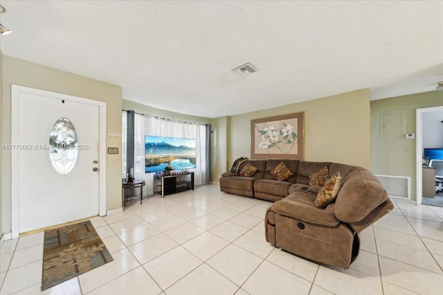 1625 E River Dr, Margate, FL 33063 - living room featuring light tile patterned flooring, a textured ceiling, and a chandelier