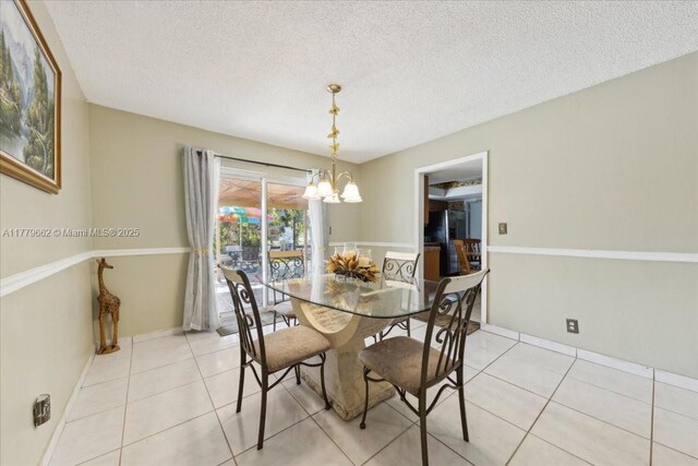 1625 E River Dr, Margate, FL 33063 - dining room with a chandelier, light tile patterned floors, and a textured ceiling