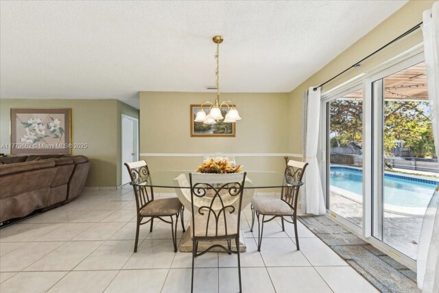 1625 E River Dr, Margate, FL 33063 - dining space featuring light tile patterned flooring, a chandelier, and a textured ceiling