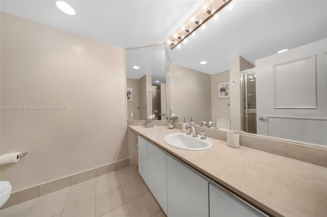 21150 NE 38th Ave Unit 2106, Aventura, FL 33180 - full bathroom featuring a shower stall, vanity, toilet, tile patterned floors, and baseboards