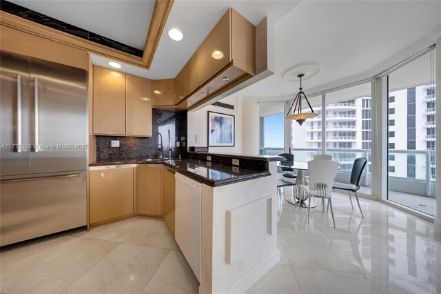 21150 NE 38th Ave Unit 2106, Aventura, FL 33180 - kitchen with dark stone counters, built in refrigerator, a peninsula, white dishwasher, and decorative backsplash