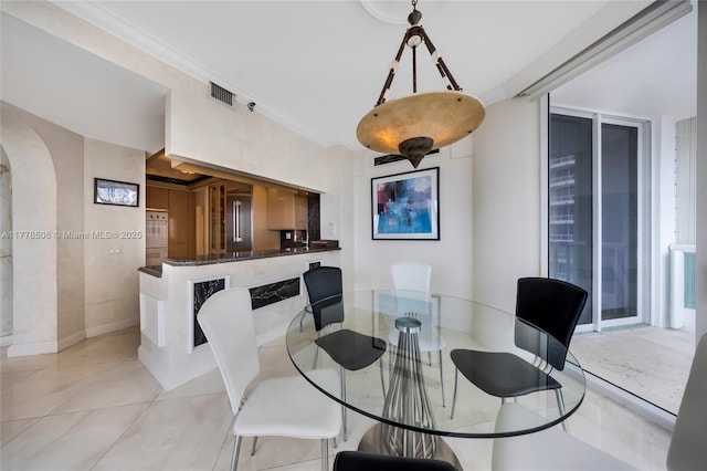 21150 NE 38th Ave Unit 2106, Aventura, FL 33180 - dining room with arched walkways, light tile patterned flooring, crown molding, and visible vents