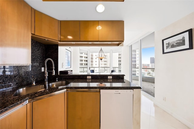 21150 NE 38th Ave Unit 2106, Aventura, FL 33180 - kitchen with brown cabinetry, a peninsula, decorative backsplash, and dishwasher