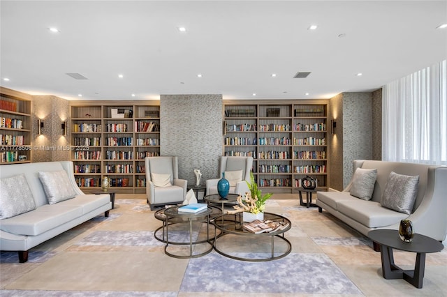 21150 NE 38th Ave Unit 2106, Aventura, FL 33180 - sitting room with wallpapered walls, wall of books, and recessed lighting