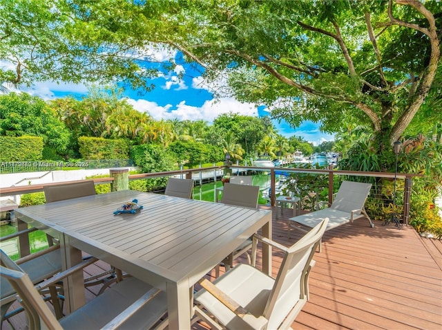 1001 S Alhambra Cir, Coral Gables, FL 33146 - wooden terrace with outdoor dining space and view of wooded area