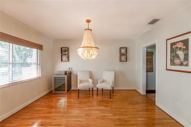 1001 S Alhambra Cir, Coral Gables, FL 33146 - sitting room with light wood finished floors, ornamental molding, a chandelier, and baseboards