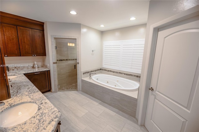 1001 S Alhambra Cir, Coral Gables, FL 33146 - full bathroom with double vanity, a shower stall, a tub with jets, and recessed lighting