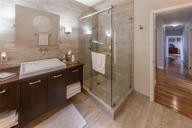1001 S Alhambra Cir, Coral Gables, FL 33146 - bathroom featuring vanity, a shower stall, and tile walls