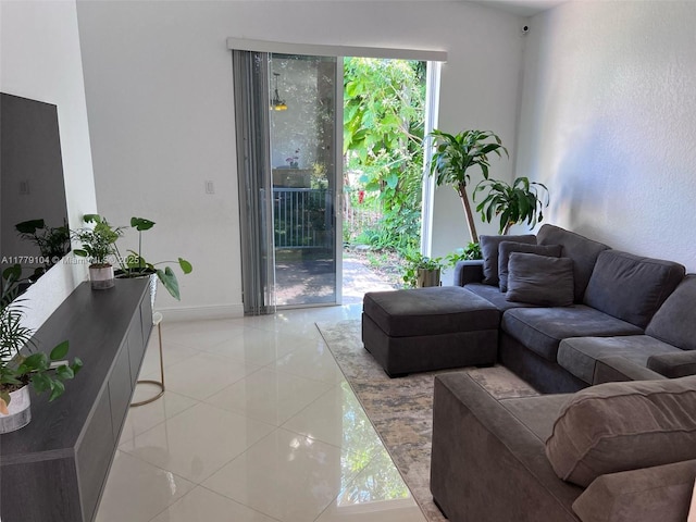 living area with light tile patterned floors and baseboards