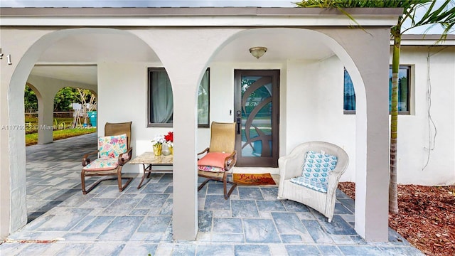 property entrance with stucco siding