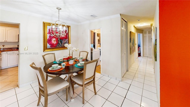 dining area with visible vents, baseboards, light tile patterned floors, a notable chandelier, and crown molding